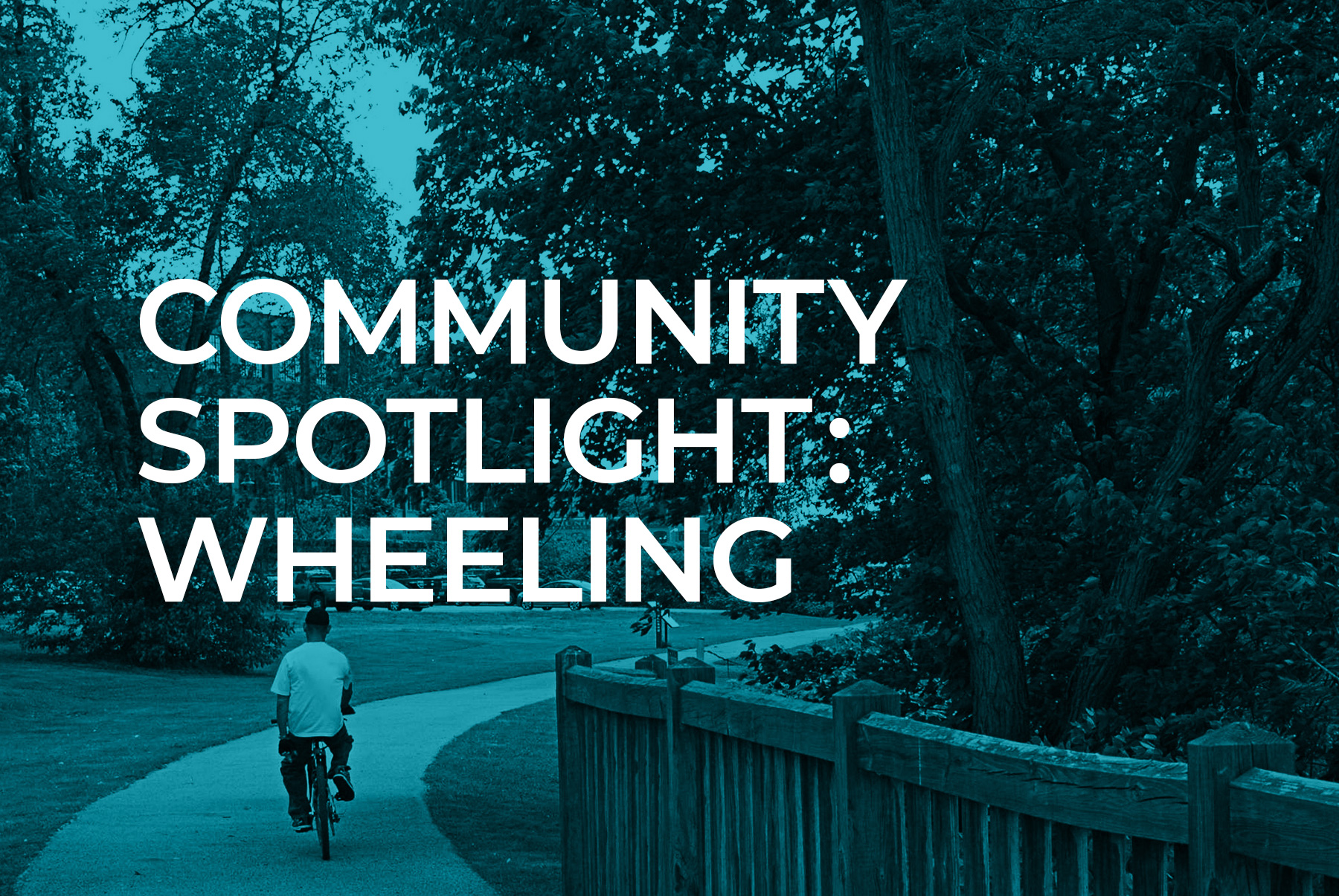 Community Spotlight: Wheeling. Man riding a bike along a walkway.