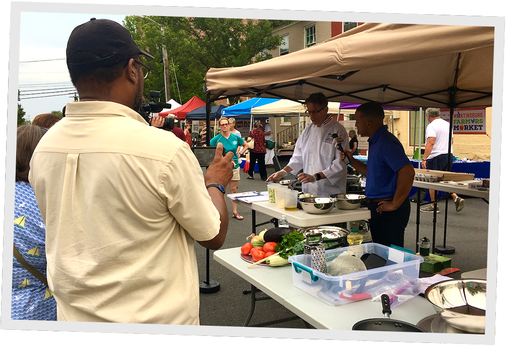 Local news covering a healthy cooking demonstration at the Martinsburg Farmers Market